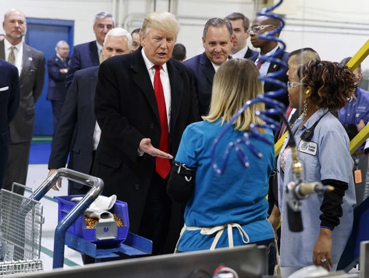 In this Dec. 1, 2016, file photo, President-elect Donald Trump greets workers during a visit to the Carrier Corp. factory in Indianapolis.