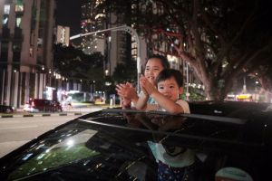 Siblings Lucas Low, four, and Hayley Low, eight, applauding in appreciation of Covid-19 front-line workers in Cantonment Road on March 30, 2020.