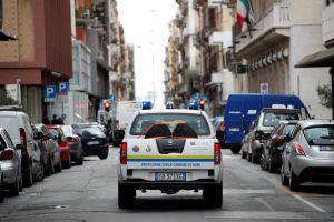 A civil protection car circulates to spread a message to invite people to stay at home in Bari, Italy, on March 27, 2020.