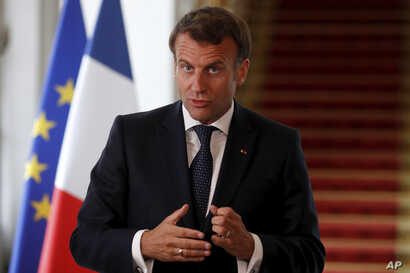 French President Emmanuel Macron speaks after a video-conference summit on vaccination at the Elysee Palace in Paris, Monday,…