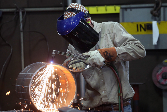 An employee welds pipe at Pioneer Pipe in Marietta, Ohio, on Oct. 25, 2016. The construction, maintenance, and fabrication company supplies products to the oil and gas industry.