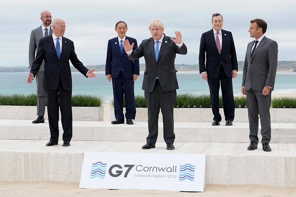U.S. President Joe Biden and British Prime Minister Boris Johnson gesture as they pose for a family photo with G-7 leaders; European Council President Charles Michel, Japan's Prime Minister Yoshihide Suga, Italy's Prime Minister Mario Draghi and French President Emmanuel Macron at the G-7 summit, in Carbis Bay, Cornwall, Britain June 11, 2021. Patrick Semansky/Pool via REUTERS TPX IMAGES OF THE DAY