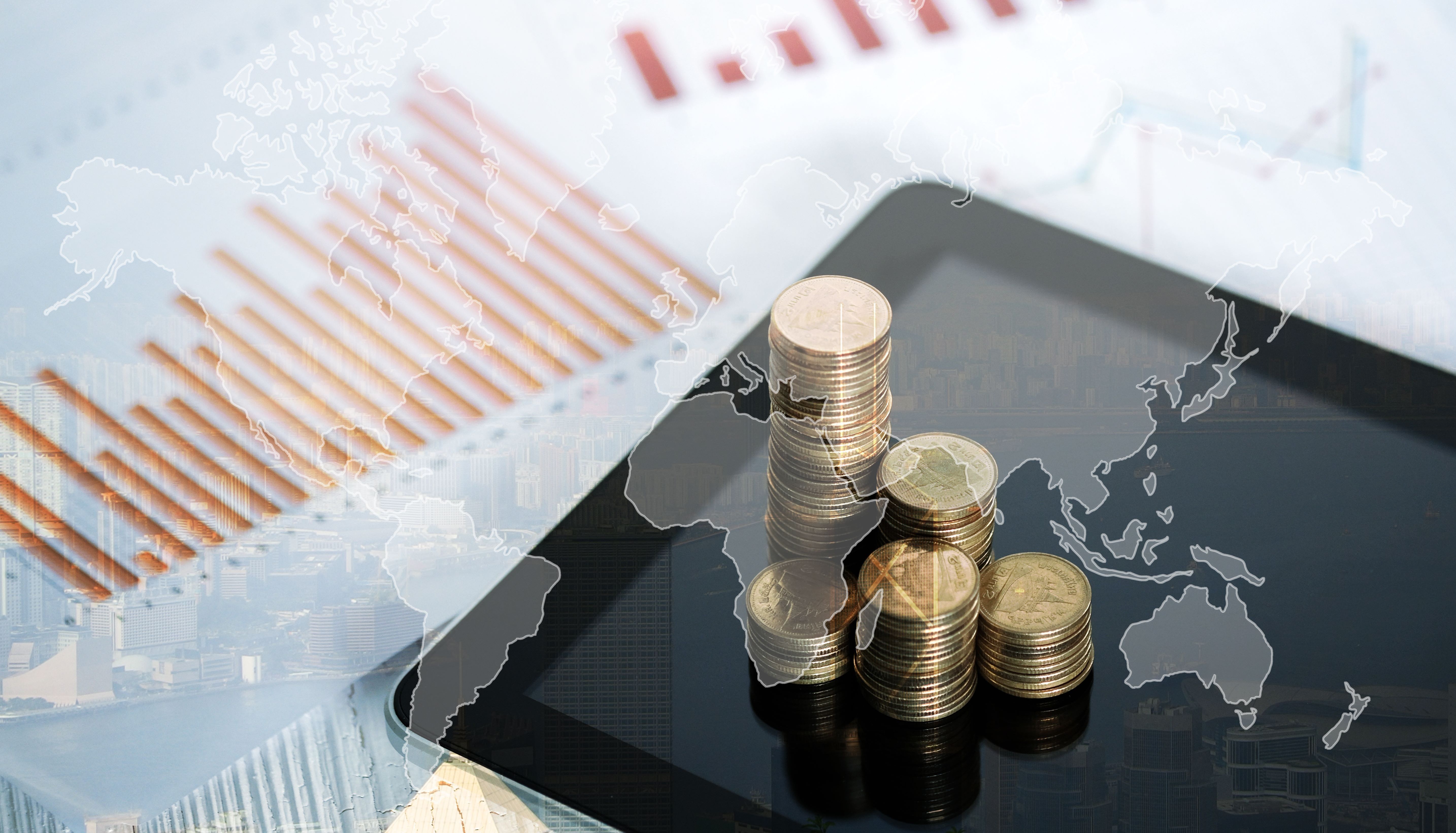 Double exposure of coin stack and tablet with city background and world map, financial graph, world map and global network business concept idea, element by NASA.